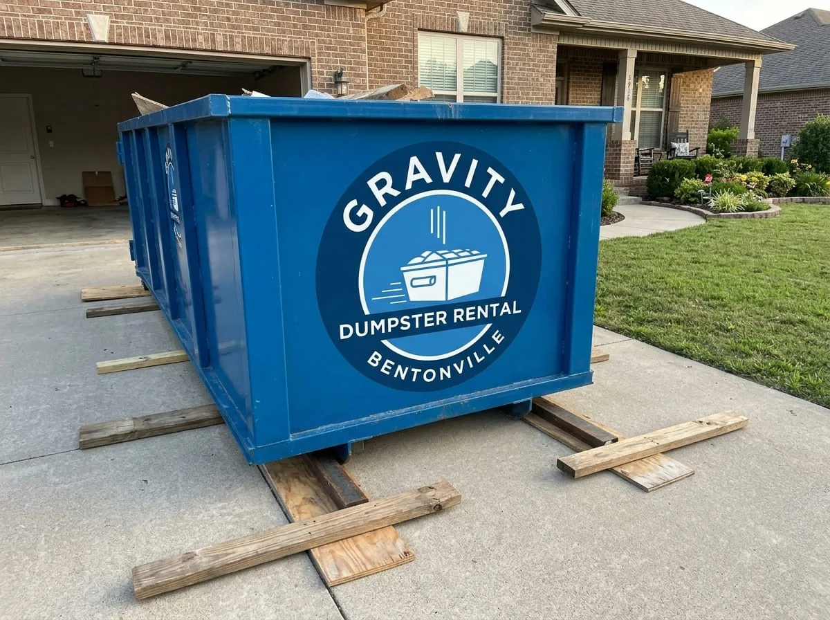 Gravity Dumpster Rental Bentonville roll-off dumpster being delivered to a Bentonville driveway